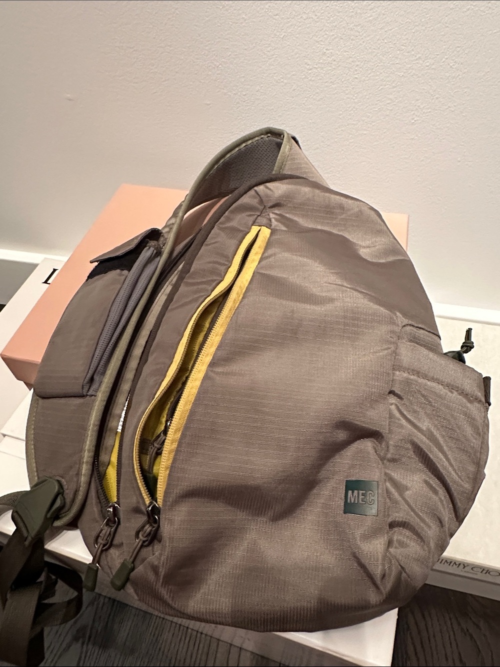 MEC Taupe Sling Backpack with Yellow Zip Accent